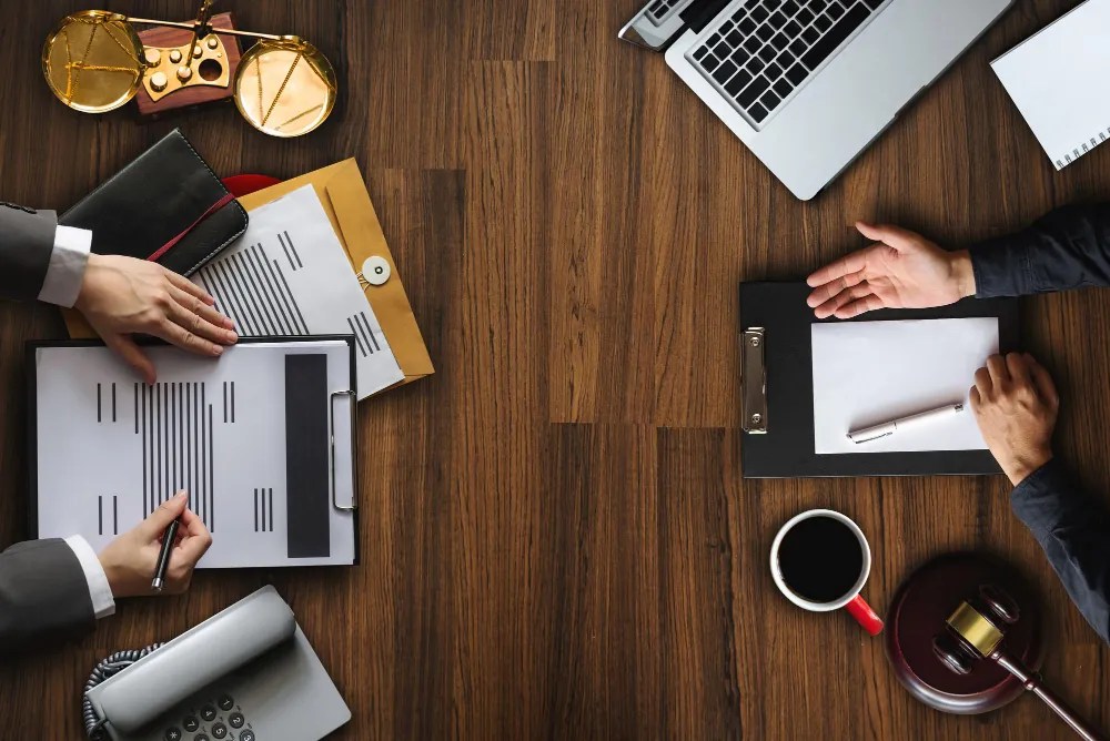 Chartered Accountants reviewing financial documents across a desk